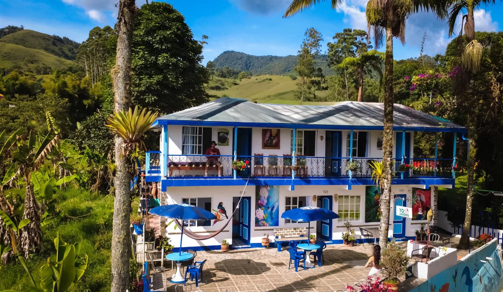 Vista Farallones hostel with its hand-painted bird murals and the mountains of Jardín